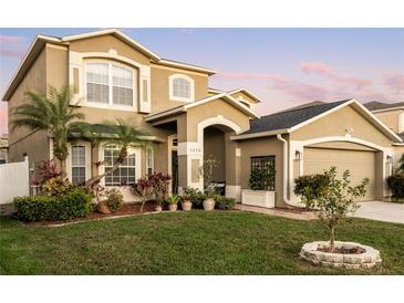 Well landscaped front yard including a palm tree accentuates the curb appeal of this home at 5278 Walnut Ridge Dr, Orlando, FL 32829