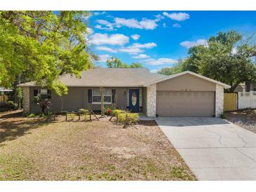 Charming single-story home with stone accents, manicured lawn, and inviting curb appeal under a bright blue sky at 655 E Lake View Rd, Lake Alfred, FL 33850