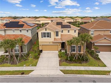 Stunning two-story home boasts well-manicured landscaping, tile roof, and solar panels for energy efficiency at 7630 Oakmoss Loop, Davenport, FL 33837