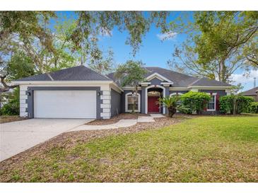 Charming single-Gathering home featuring a well-manicured lawn and a classic color scheme at 827 Royalwood Ln, Oviedo, FL 32765