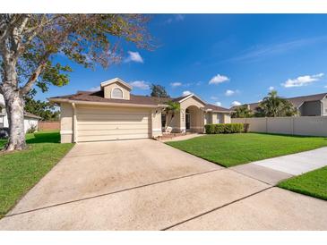 Charming one-story home with a two car garage, well-manicured lawn, and welcoming entryway at 2901 Eagle Lake Dr, Orlando, FL 32837