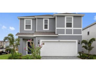 Charming gray two-story home featuring a well-maintained lawn and inviting curb appeal at 3356 Lilac Way, Davenport, FL 33897