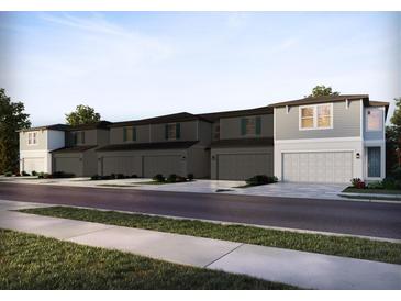 Charming townhomes feature neutral paint, attached garages, and well-maintained landscaping at 4353 Switchgrass Ln, St Cloud, FL 34772
