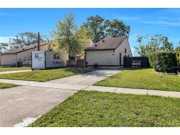 Charming single-story home with a well-manicured lawn and sunny sky at 626 Golden Sunshine Cir, Orlando, FL 32807
