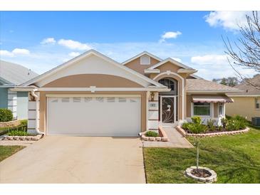 Charming single-story home featuring a pristine two-car garage and well-manicured landscaping at 912 Challenger Ave, Davenport, FL 33897