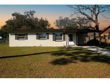 Charming single-story home with neutral paint, tidy landscaping, and a convenient attached carport at 925 Valleydale Ave, Deland, FL 32720