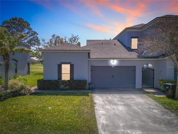 Charming home featuring a two-car garage, lush landscaping, and a well-manicured lawn in a desirable neighborhood at 20604 Maxim Pkwy, Orlando, FL 32833