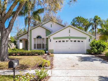 Charming single-story home with a well-manicured lawn, mature trees and attached two car garage at 2112 White Eagle St, Clermont, FL 34714