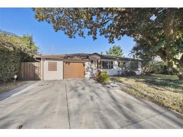 Charming single-story home with a well-maintained front yard, attached garage and inviting curb appeal at 4249 Kendrick Rd, Orlando, FL 32804