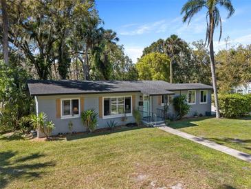 Charming single-story home with tidy landscaping and a quaint walkway leading to the front door at 430 S Virginia Ave, Sanford, FL 32771