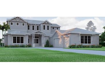 Stately two-story home featuring a metal roof, front-facing three-car garage, and neatly manicured landscaping at 4654 Thornlea Rd, Orlando, FL 32817