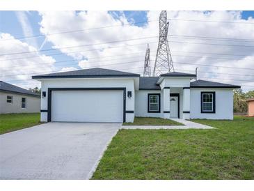 Charming single-story home with a two-car garage and well-manicured lawn at 17046 Sw 44Th Cir, Ocala, FL 34473