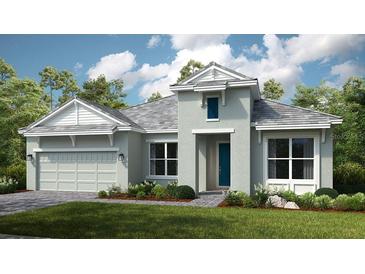Charming single-Gathering home featuring a two-car garage, manicured lawn and stone accents, showcasing curb appeal at 5640 Nevis Ter, Kissimmee, FL 34758