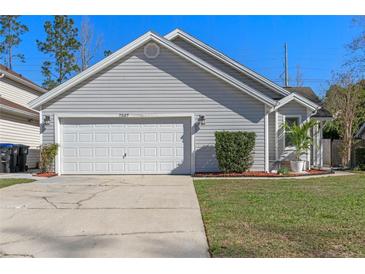Charming single-Gathering home featuring a two-car garage and a well-maintained lawn at 7507 Pacific Heights Cir, Orlando, FL 32835