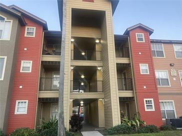 Multi-story condo building showing the balconies and colorful red and tan facade at 2207 Antigua Pl # 736, Kissimmee, FL 34741