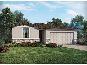 Charming single-story home with a well-maintained lawn, stone accents, neutral paint, and attached two-car garage at 2310 White Tail St, Davenport, FL 33837