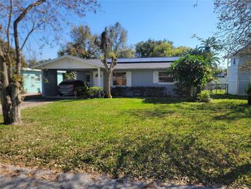 Charming single-story home with carport and lush green lawn at 4202 Mizell St, Orlando, FL 32812