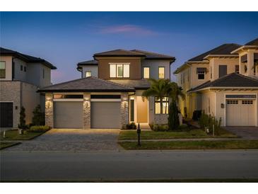 Beautiful two-story home featuring a well-manicured lawn, stone accents, and a spacious two-car garage at 15847 Vetta Dr, Bella Collina, FL 34756