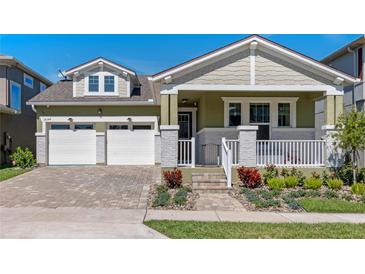 Charming home featuring a two-car garage and a beautifully landscaped front yard at 16144 Parkwyn St, Winter Garden, FL 34787