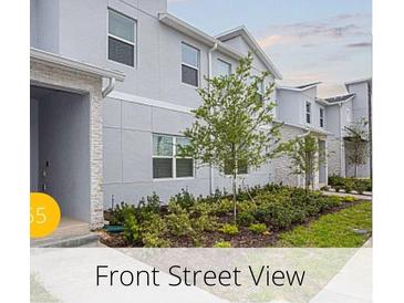 Charming two-story home showcasing manicured landscaping and a contemporary facade at 218 Ocean Course Ave, Davenport, FL 33896