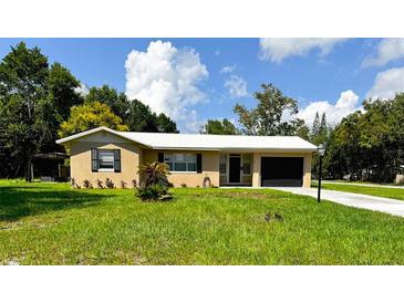 Charming single-story home with lush green lawn, a one car garage and lovely curb appeal at 236 Eldorado Dr, Debary, FL 32713