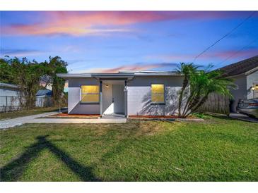 This exterior shows a house and its front lawn at dusk at 859 Neuse Ave, Orlando, FL 32804