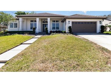 Charming one-story home featuring manicured landscaping, a two-car garage, and a welcoming entrance at 442 Flora Creek Ct, Lake Mary, FL 32746