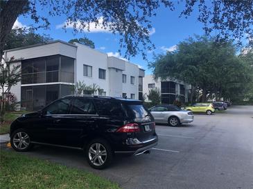 Apartment complex featuring on-site parking and exterior facade at 2597 Oak Park Way # 205, Orlando, FL 32822