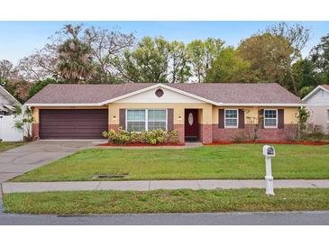 Charming single-story home featuring a well-manicured lawn and attached garage at 2900 E Grant Ave, Orlando, FL 32806