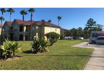 Inviting two-story condo featuring a meticulously maintained lawn and palm trees in a well-kept community at 3714 Palm Desert Ln # 5337, Orlando, FL 32839