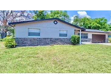 Charming single-story home with a well-manicured lawn and a two-car garage at 1420 Continental Dr, Daytona Beach, FL 32117
