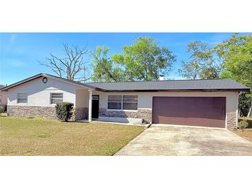 Charming single-story home with a well-maintained lawn and attached two-car garage at 1420 Continental Dr, Daytona Beach, FL 32117