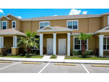 Inviting townhouse featuring a well-maintained lawn and a shared entrance, perfect for comfortable living at 1523 Still Dr, Clermont, FL 34714