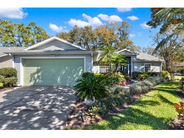 Charming single Gathering home featuring a landscaped front yard and attached two car garage at 4721 Tara View Road, Leesburg, FL 34748