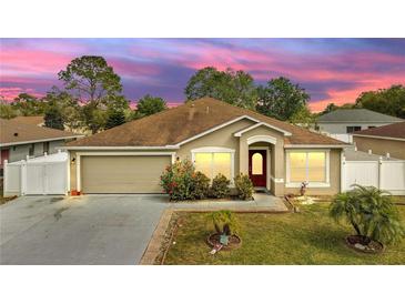 Charming single-story home with a well-manicured lawn and beautiful landscaping at 639 Mesilla Dr, Kissimmee, FL 34758