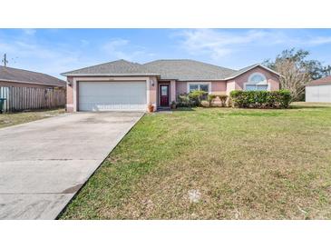Charming single-story home with well-maintained lawn, two-car garage, and inviting curb appeal at 2540 Courtland Blvd, Deltona, FL 32738