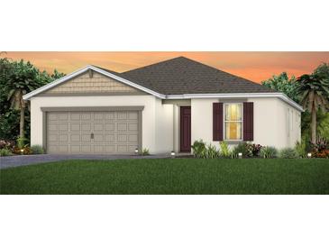 Charming single-story home featuring a two-car garage, manicured lawn, and classic architectural details at 2721 Serenity Meadow Dr, Kissimmee, FL 34744