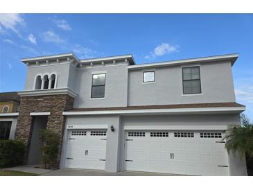 Charming two-story home featuring a two-car garage and a stone facade accent at 3039 Boating Blvd. Blvd, Kissimmee, FL 34746
