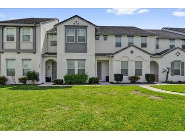 Charming townhome with well-maintained lawn and neutral-colored exterior at 394 Captiva Dr, Davenport, FL 33896