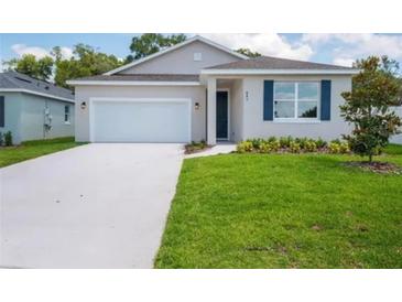 Charming single-Gathering home featuring a two-car garage, well-manicured lawn, and inviting curb appeal at 601 Dominish Estates Dr, Apopka, FL 32712