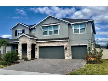 Two-story home with stone accents, a two-car garage and well-maintained landscaping at 760 Annabell Ridge Rd, Minneola, FL 34715