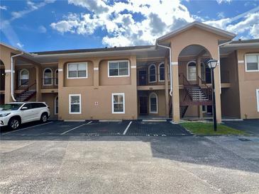 Well-maintained condo building with private parking and easy access to units via outdoor staircases at 8830 Coral Palms Ct # A, Kissimmee, FL 34747