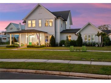 Charming two-story home with a covered porch, lush lawn, and classic architecture at 1091 Eaglecrest Dr, Winter Garden, FL 34787