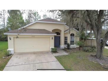 Charming single-story home featuring a two-car garage and well-maintained front yard at 13440 Fordwell Dr, Orlando, FL 32828