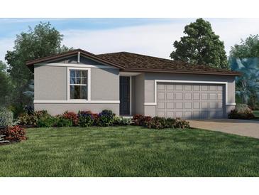 Charming single-story home with a well-manicured lawn and colorful flowerbeds at 1550 Mermaid Way, Haines City, FL 33844