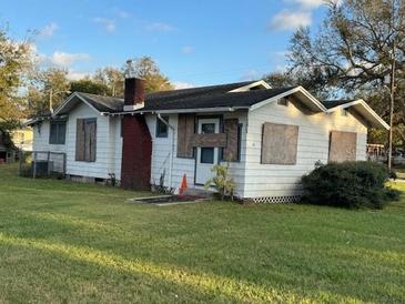 Charming single-story home with a spacious front yard and classic architectural details at 1811 S Westmoreland Dr, Orlando, FL 32805