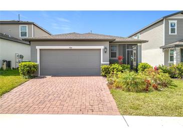 Charming single-Gathering home featuring a brick driveway, well-maintained landscaping, and a neutral color palette at 3764 Shoveler Ave, Leesburg, FL 34748