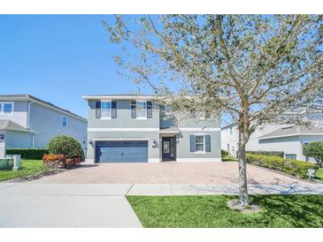 Charming two-story home with a brick driveway and well-manicured landscaping, showcasing curb appeal at 480 Burma St, Kissimmee, FL 34747