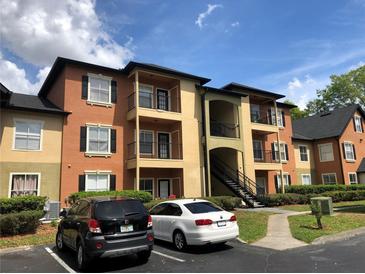 View of the building's exterior, showcasing the architecture and surrounding landscape with parking at 5959 Westgate Dr # 1526, Orlando, FL 32835