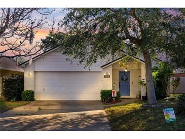 Charming single-story home featuring a well-manicured lawn, brick facade, and a welcoming blue front door at 1493 Hyde Park Dr, Winter Park, FL 32792